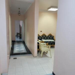 a living room with a couch and a chair at OS & MA Luxor in Luxor +3 photos