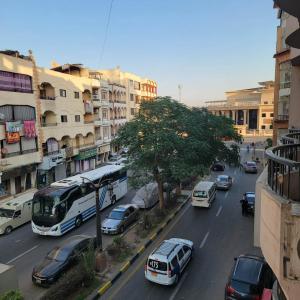 a busy city street with cars and a bus at OS & MA Luxor in Luxor