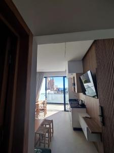 a kitchen and dining room with a view of a balcony at Casa del mar in Agadir nʼ Aït Sa