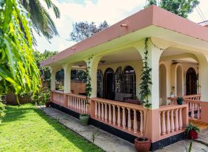a small house with a pink roof at Hansat Homestay Residence in Arusha
