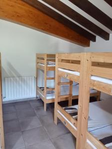 a room with two bunk beds and a wooden ceiling at Amaiurko Aterpetxea in Maya del Baztán