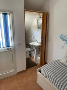 a bathroom with a bed and a sink and a toilet at Casa Ida in Sestri Levante +15 photos