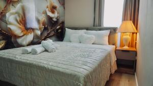 a bedroom with a bed with towels on it at Apartments St Jakov in Međugorje