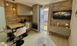 a kitchen with a counter and a table in a room at Apartments St Jakov in Međugorje