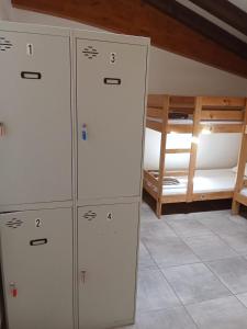 a room with four lockers and a bunk bed at Amaiurko Aterpetxea in Maya del Baztán