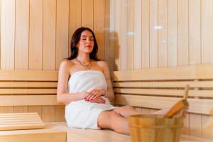 a woman is sitting in a sauna at Villa Aurora mit Sauna und Whirlpool in Dranske +22 photos