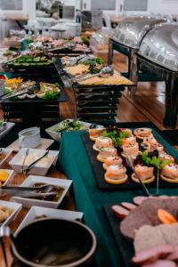 a buffet with many plates of food on a table at Hotel Senator Konferencje & SPA in Starachowice