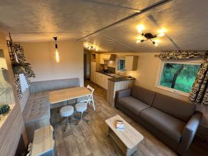an overhead view of a living room and kitchen in a tiny house at De Wilg Beerse, tiny house with meadow view, animals in Beerse +36 photos