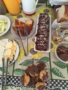 a table topped with plates of food and desserts at Recanto Ursa Maior in Monte Verde +86 photos