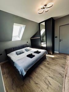 a bedroom with a bed and a ceiling fan at Podlaski Chill in Przejma Wielka +26 photos