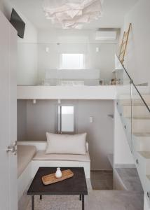 a small room with a table and a staircase at Kythea Suites Kythnos in Kithnos