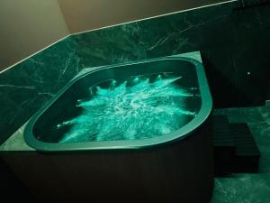 a green tub with water in it in a bathroom at Podlaski Chill in Przejma Wielka