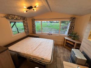a bedroom with a bed in a tiny house at De Wilg Beerse, tiny house with meadow view, animals in Beerse