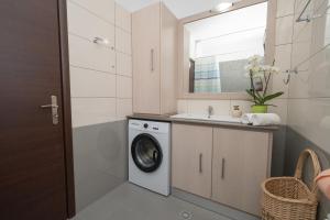a bathroom with a washing machine and a sink at Ocean Breeze Residence in Kámpos +104 photos