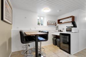 a small kitchen with a table and a microwave at Grettir Guesthouse Downtown Charm in Reykjavík