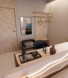 a room with a bed with a chair and a table at The Corner Park Hotel in Antalya