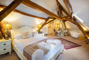 a bedroom with a bed and a tub in a room at Logis Hotel De France in La Chartre-sur-le-Loir