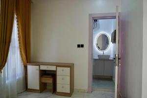 a bathroom with a sink and a mirror at Yande Homes in Mama +8 photos