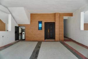 an empty hallway with a door in a building at Yande Homes in Mama