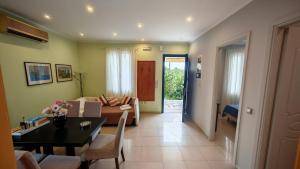 a living room with a couch and a table at Suli Residences in Pesádha