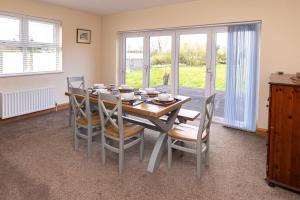a dining room with a table and chairs at Copperbeech Farm Guest House in Moira