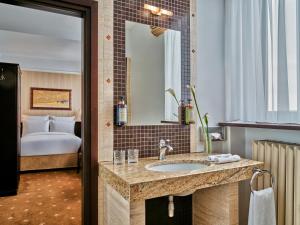a hotel bathroom with a sink and a bed at Hotel President in Bielsko-Biała +78 photos