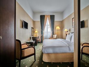 a hotel room with a bed and a window at Hotel President in Bielsko-Biała