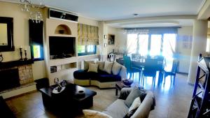 a living room with a couch and a table at Villa Arena Theologos in Theologos