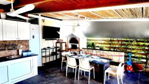 a kitchen with a table with chairs and a fireplace at Villa Arena Theologos in Theologos