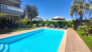 a swimming pool in front of a house at Villa Arena Theologos in Theologos
