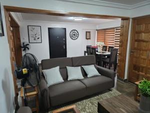 a living room with a couch and a dining room at Green Life Apartment in Sakumona