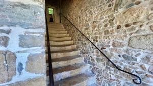 a staircase in a stone building with a window at Hotel Le Galambre in Nîmes