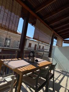 a wooden table and chairs on a patio at Nido Estivo 1 in Nea Skioni