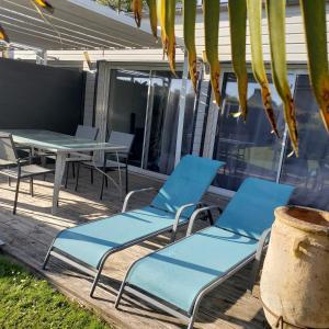 a pair of chairs and a table on a patio at La maison de Brijy in Pleslin-Trigavou