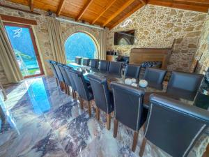 a conference room with a long table and chairs at Villa Rokka Luxe - Free Private Heated Pool, Hot Tub, and more in Kissamos