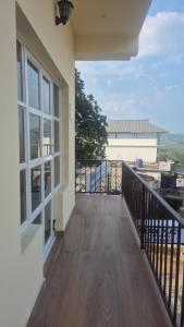 a balcony with a view of a building at Grace place in Vagamon