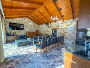 a kitchen with chairs and a bar in a room at Villa Rokka Luxe - Free Private Heated Pool, Hot Tub, and more in Kissamos