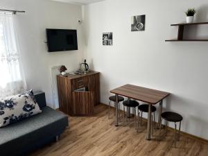 a living room with a table and a couch at Andromeda in Mikoszewo