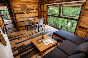 a living room with a couch and a table at Treehouse Tulum H2Ojos in Tulum +20 photos