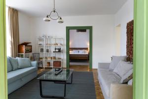 a living room with a couch and a glass table at Nostalgia in Turda