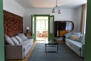 a living room with a couch and a tv at Nostalgia in Turda