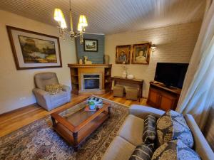 a living room with a couch and a coffee table at Hotel Vovó Carolina in Gramado +191 photos