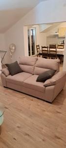 a large couch in a living room with a table at Apartments Stanko in Sumartin