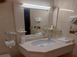 a bathroom with a sink and a mirror at فندق السلطان ان Alsultan Inn Hotel in Jazan +11 photos