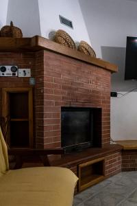 a brick fireplace with a television on top of it at Casa Vacanze VENDITTO in Pietraroia +6 photos