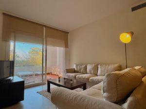 a living room with a couch and a tv at Life Apartments Costa Ballena in Costa Ballena