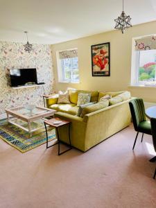 a living room with a couch and a table at The Coach House in Par