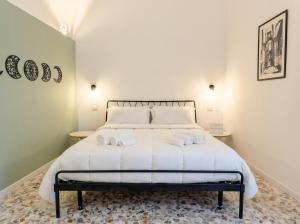 a bedroom with a bed with two towels on it at Andromeda in Modugno