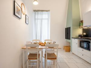 a kitchen with a white table and chairs in a room at Andromeda in Modugno +12 photos
