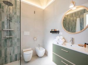 a bathroom with a shower and a toilet and a sink at Andromeda in Modugno